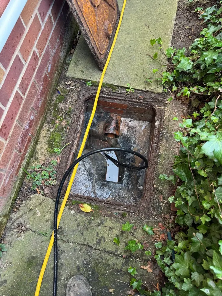 Outside drain chamber being unblocked with a jetting hose